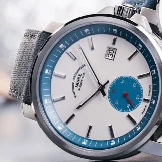 29er Big Small Seconds with white and petrol blue dial on grey canvas strap lies on its side.