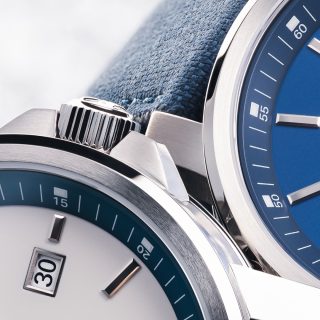 Section of the case of the 29er Big Small Seconds in stone white and nautical blue