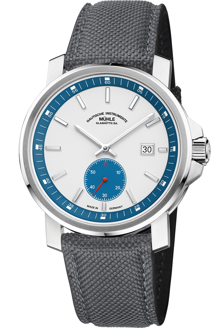 Frontalansicht der Armbanduhr 29er Big Kleine Sekunde mit weißem Zifferblatt, petrolfarbenem Hilfszifferblatt und Rehaut im silbernen Gehäuse am grauen Canvasband.