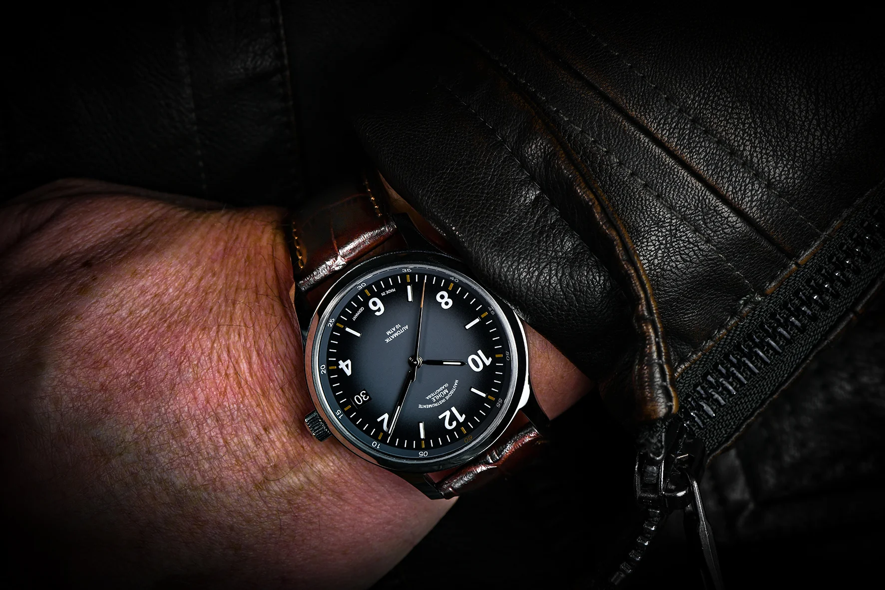 Wristshot der Lunova Datum, einer Armbanduhr mit grauem Zifferblatt, weißen Indizes, silbernem Gehäuse und braunem Lederband.