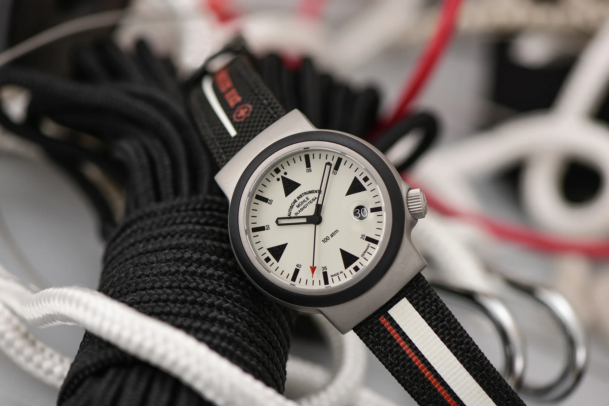 S.A.R. Rescue-Timer LUMEN mit schwarz-weiß-rotem Canvasband liegt schräg auf verschiedenen Seilen.