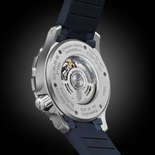 Rückseite der Seebataillion GMT am blauen Kautschukband mit Blick ins Uhrwerk durch den gläsernen Gehäuseboden